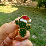 Load image into Gallery viewer, Christmas Cactus Enamel Pin with Santa Hat | Holiday Desert Plant Lapel Pin | Festive Cactus Badge | Stocking Stuffer Gift

