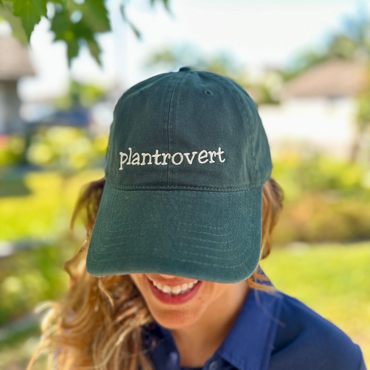 Woman wearing green plantrovert embroidered hat